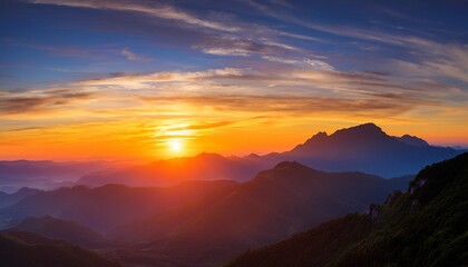 Fototapeta premium breathtaking sunrise over mountains with vibrant colors and clouds creating a serene atmosphere perfect for nature lovers