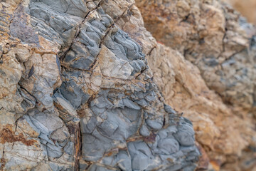 Greenstone / Metamorphic rock. Weathered. Dark-green to red, altered basaltic volcanic rocks. altered to clay minerals.Coyote Point Beach, San Mateo, California. San Francisco Peninsula / Bay