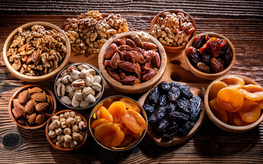 variety of dried fruits and nuts displayed on a wooden tablet