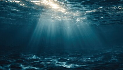 Underwater scene, sunlight beams through dark, deep water