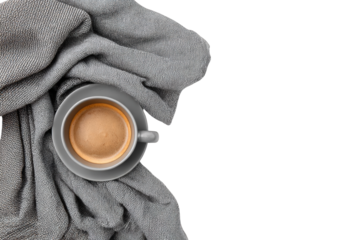 A grey coffee cup on a grey blanket