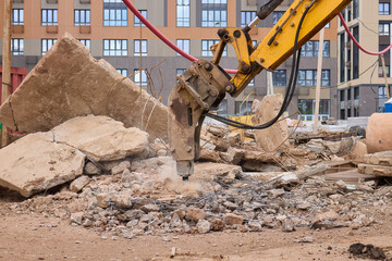 A bustling construction site filled with heavy machinery and ongoing demolition work
