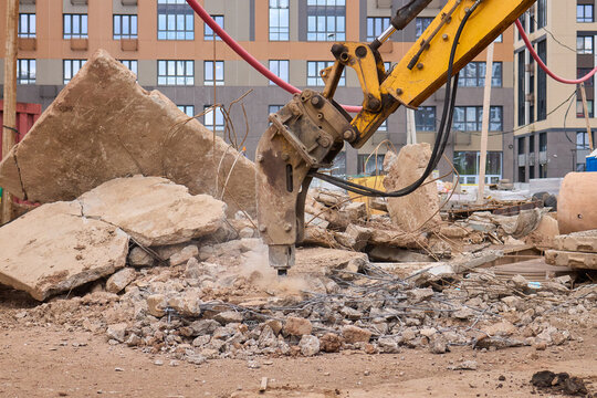 A bustling construction site filled with heavy machinery and ongoing demolition work