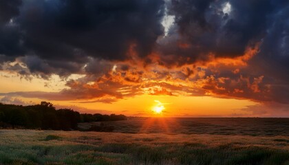 dramatic sunset with fiery orange and dark clouds in dynamic evening sky