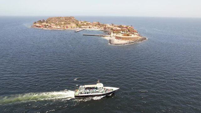 SENEGAL - 7.14.2025 - Fantastic aerial view of a ferry sailing past Senegal's Goree Island, a former hub of the slave trade.