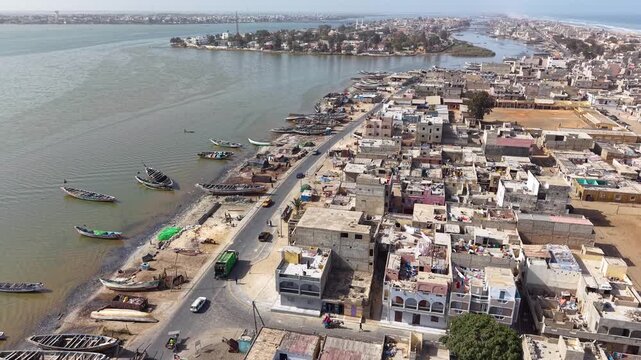 SENEGAL - 7.16.2025 - Fantastic aerial footage moving up a boat-packed beach on Senegal's Island of Saint-Louis, bound for a river.