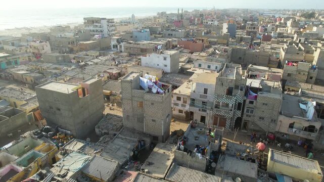 SENEGAL - 7.16.2025 - Stunning aerial footage moving across neighborhood rooftops to the beach on Senegal's Island of Saint-Louis.