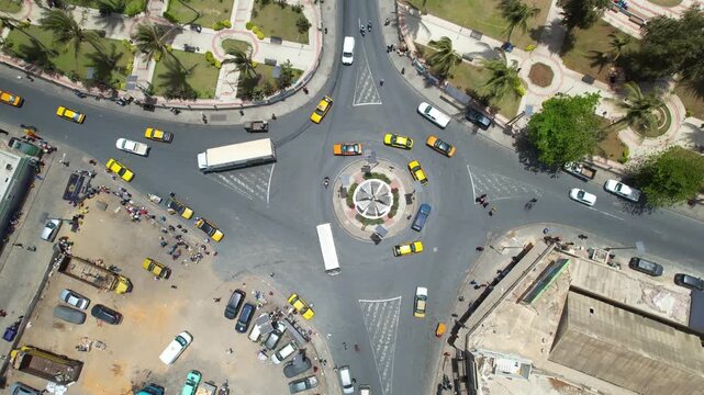 SENEGAL - 7.16.2025 - Excellent bird's eye view of cars and trucks navigating a traffic circle on Senegal's Island of Saint-Louis.