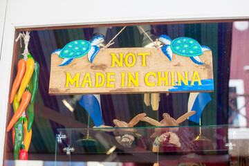 Handmade wooden shop sign with turtles