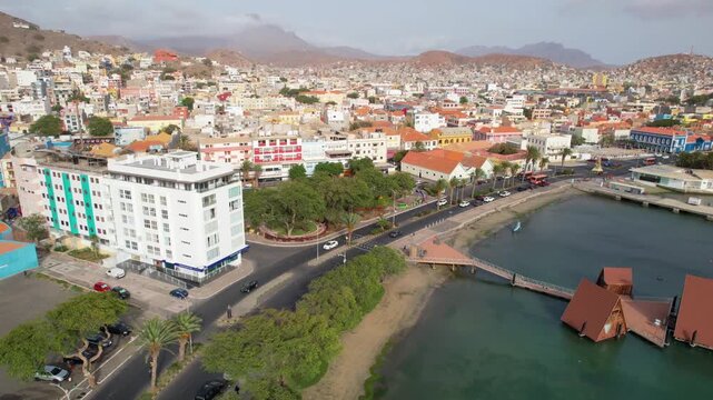 CAPE VERDE - 8.4.2025 - Good aerial footage moving down a port of Mindelo, Cape Verde, where cars are driving by.