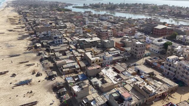 SENEGAL - 7.21.2025 - Excellent aerial footage passing over the beach and towards the Senegal River on the Island of Saint-Louis.