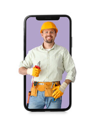 Male builder with tools on lilac background
