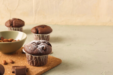 Tasty chocolate cupcakes on table