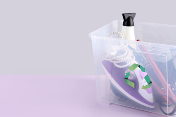 Recycle bin with different household appliances on color background