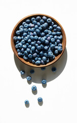 Blueberries in wooden bowl on a white