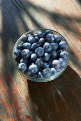 Blueberries in bowl on a wooden