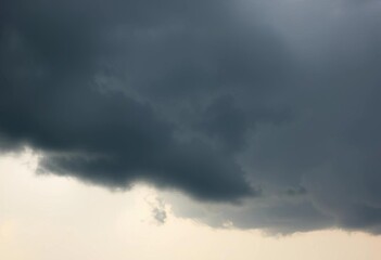 A dark, ominous storm cloud against a bright white sky,  dramatic,  illustration