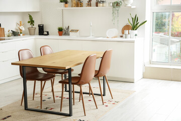 Clean wooden table in interior of modern kitchen