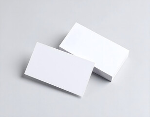 A stack of three blank rectangular cards rests on a textured white surface. 