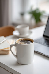 cozy coffee mug placed on pristine white table next to open notebook exuding warm atmosphere