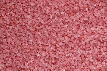Extreme close-up macro of pink flavored sugar crystals, creating a vibrant and detailed abstract...
