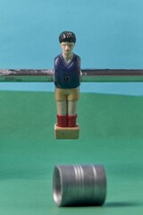 Fototapeta premium A detailed view of a foosball player figurine on a rod in an outdoor setting, depicting the game and iconic design elements