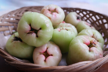Fresh Green Rose Apples in Rustic Basket
