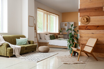 Interior of modern bedroom with houseplants, green decor elements and wooden wall