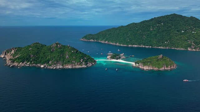 Koh Nang Yuan, Koh Tao island Thailand Aerial drone pan orbit. Beach, mountain and jungle, sand blue turquoise water.