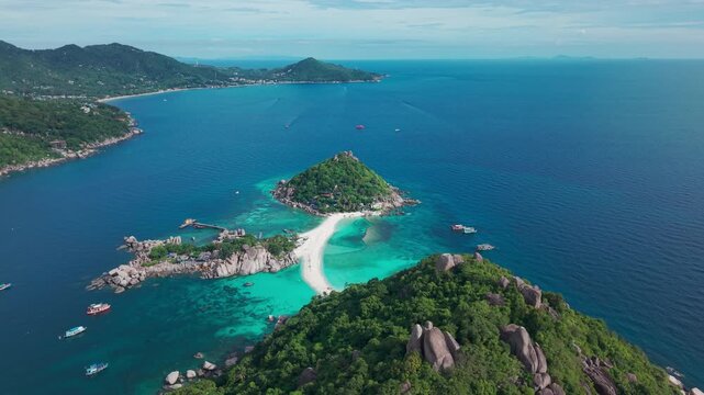 Koh Nang Yuan, Koh Tao island Thailand Aerial drone pan orbit. Beach, mountain and jungle, sand blue turquoise water.