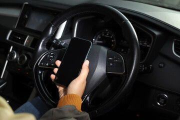 Fototapeta premium The driver searches for directions on his phone