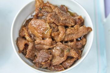 Close-up view of stew pork in sweet brown soup in bowl
