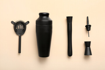 Different bartender utensils on beige background, closeup