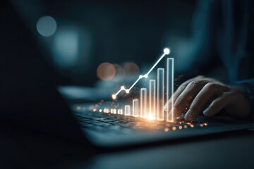 Hands on laptop keyboard with glowing graph upward trend