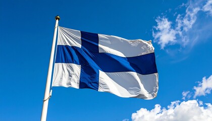 Finland's national flag, with its iconic blue Nordic cross on a white background, waves against a clear blue sky dotted with soft clouds, embodying national pride and heritage