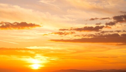 Fototapeta premium Vibrant sunset with orange and yellow hues, fluffy clouds