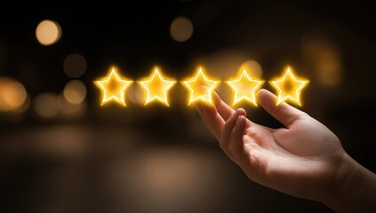 Hand holding glowing golden stars on dark background