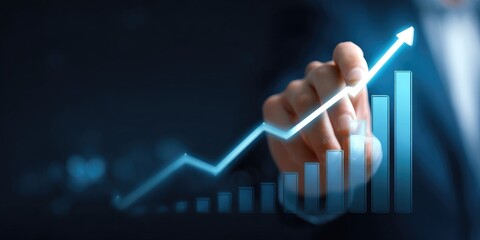 Hand drawing a glowing upward trend graph on a dark background