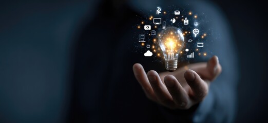 Person's hand holds a glowing lightbulb with digital icons swirling around it