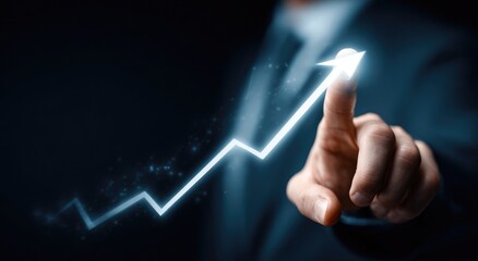 Businessman's finger points to a glowing upward graph, signifying growth