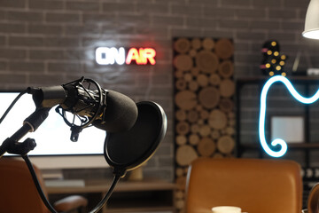 Stand with microphone in dark podcaster's studio, closeup
