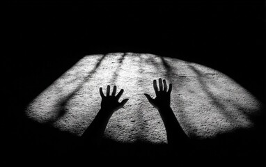 Two outstretched hands in shadow