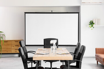 Interior of conference hall with table and projector screen