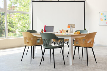 Interior of conference hall with table and projector screen