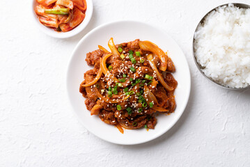 Korean stir fried spicy pork (Bulgogi) with cooked rice and kimchi on white background, Top view