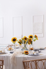 Elegant table serving with plates, folded napkins and beautiful sunflowers