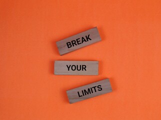 Motivational Quote 'Break Your Limits' On Wooden Blocks with orange background