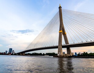 Obraz premium Modern cable-stayed bridge over a river at twilight