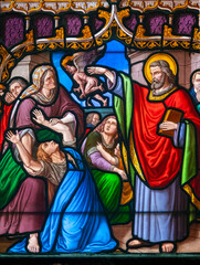 Fototapeta premium Stained glass (19th century) of Saint Peter exorcising a woman possessed by a devil.