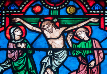 Stained glass (19th century) of Jesus Christ crucified on the cross represented with Marie and Saint John.